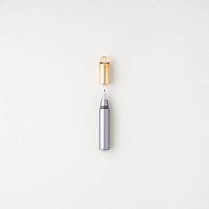 Tom's Studio Field Mouse pen in Lilac (soft purple), uncapped with brass loop cap above, on textured white background