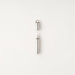 Tom's Studio Field Mouse pen in Stainless Steel, uncapped with stainless steel loop cap above, on textured white background