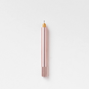 Tom's Studio Lumos Mini refillable pen in Blush (soft pink), cap posted with tip exposed, on white background