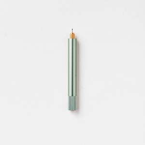 Tom's Studio Lumos Mini refillable pen in Sage (light green), cap posted with tip exposed, on white background