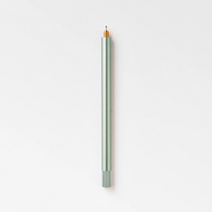 Tom's Studio Lumos Pro Single in Sage (pale green), fineline tip exposed, cap posted, on textured paper