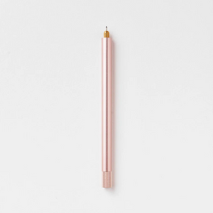 Tom's Studio Lumos Pro Single in Rose Gold (soft pink), fineline tip exposed, cap posted, on textured paper