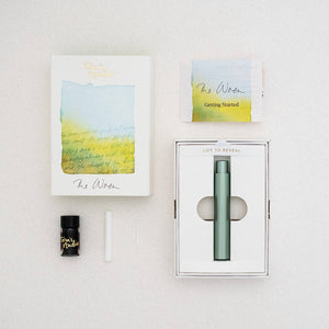 Tom's Studio Wren pen in Sage (green) with box contents: sleeve, instructions, fibre tip, reservoir, and ink sample