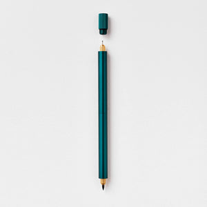 Tom's Studio Lumos Pro Duo in Ivy (dark green), fineline and brush tips exposed, cap shown above, on textured paper