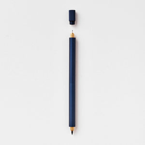 Tom's Studio Lumos Pro Duo in Midnight (dark navy), fineline and brush tips exposed, cap shown above, on textured paper