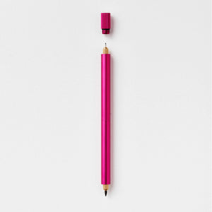 Tom's Studio Lumos Pro Duo in Raspberry (deep pink), fineline and brush tips exposed, cap shown above, on textured paper