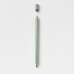 Tom's Studio Lumos Pro Duo in Sage (pale green), fineline and brush tips exposed, cap shown above, on textured paper